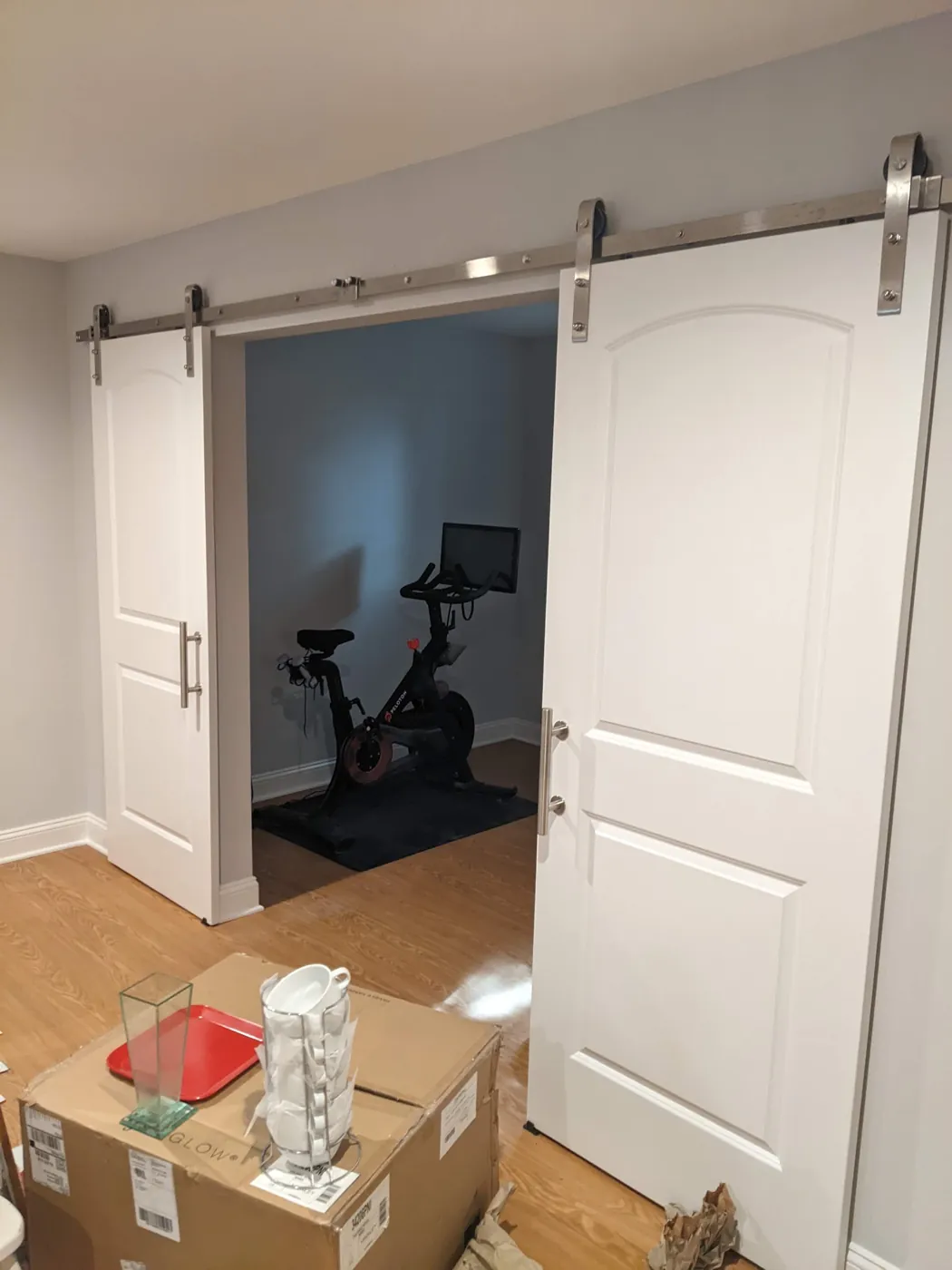 Renovated room with a sliding barn door, rubber floor, and recessed lighting in a Monmouth County, NJ home