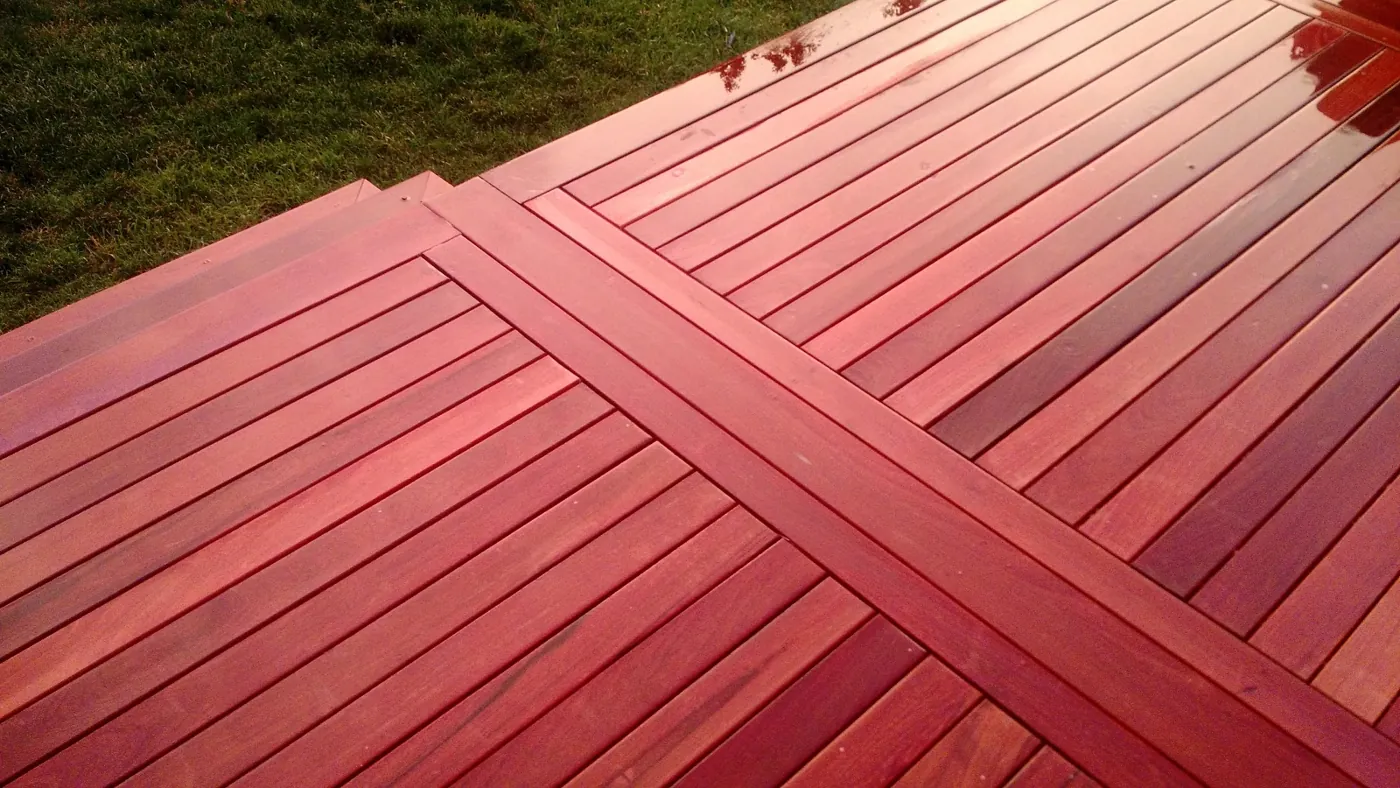 Close-up of an ipe hardwood deck with a herringbone field and picture-frame border in Monmouth County, NJ