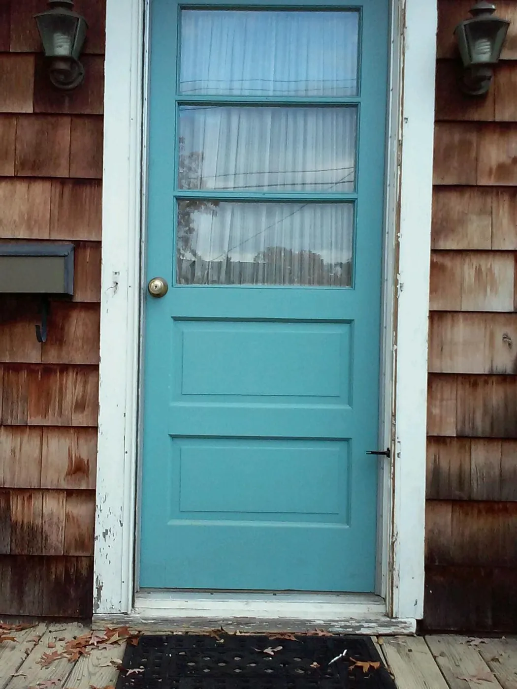 Before: an old painted wood entry door with peeling paint and a worn frame on a cedar shake house in Monmouth County, NJ